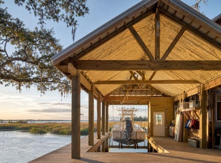 Professionally insulated waterfront boathouse with spray foam insulation along the Savannah River at sunrise.